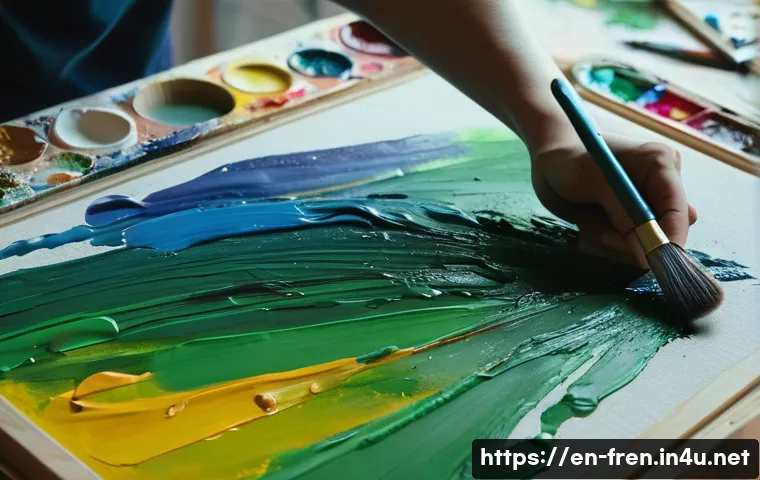 프랑스어 미술 용어 - A detailed close-up of an artist&rsquo;s hand skillfully applying thick, textured brushstrokes with a vari...